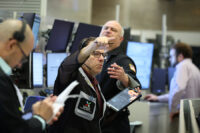 Futures-options traders work on the floor at the New York Stock Exchange's NYSE American (AMEX) in New York City, U.S., January 6, 2026. REUTERS/Brendan McDermid/File Photo