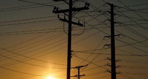 FILE PHOTO: Electrical transmission poles and lines are shown in the early morning of a hot summer day in Commerce, California, U.S, August 7, 2025. REUTERS/Mike Blake/File Photo