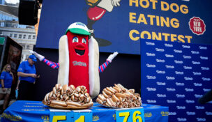 FILE PHOTO: Frankie, the mascot for Nathan's Famous hot dogs, excites the audience at the official weigh-in ceremony, ahead of the Coney Island's 2025 Nathan's Famous Fourth of July International Hot Dog Eating Contest in New York City, U.S., July 3, 2025. REUTERS/Angelina Katsanis/File Photo