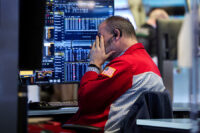 A trader works on the floor at the New York Stock Exchange (NYSE) in New York City, U.S., January 13, 2026. REUTERS/Brendan McDermid/File Photo
