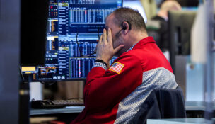 A trader works on the floor at the New York Stock Exchange (NYSE) in New York City, U.S., January 13, 2026. REUTERS/Brendan McDermid/File Photo