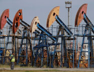 A security guard stands near disused oil pump jacks at the Airankol oil field operated by Caspiy Neft in the Atyrau Region, Kazakhstan August 22, 2024. REUTERS/Pavel Mikheyev