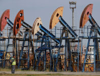 A security guard stands near disused oil pump jacks at the Airankol oil field operated by Caspiy Neft in the Atyrau Region, Kazakhstan August 22, 2024. REUTERS/Pavel Mikheyev