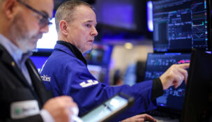 Traders work on the floor at the New York Stock Exchange (NYSE) in New York City, U.S., January 21, 2026. REUTERS/Brendan McDermid