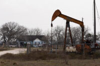An oil pumpjack in front of a house in Ganado, Texas, U.S., January 8, 2026. REUTERS/Antranik Tavitian