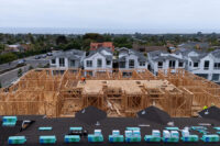 A drone view shows construction personnel working on a multi-home residential project by Shea Homes in Encinitas, California, U.S. July 21, 2025. REUTERS/Mike Blake/File Photo