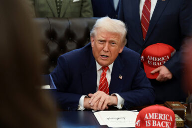 U.S. President Donald Trump sits behind a bill he signed to end the partial government shutdown, at the White House in Washington, D.C., U.S., February 3, 2026. REUTERS/Evelyn Hockstein