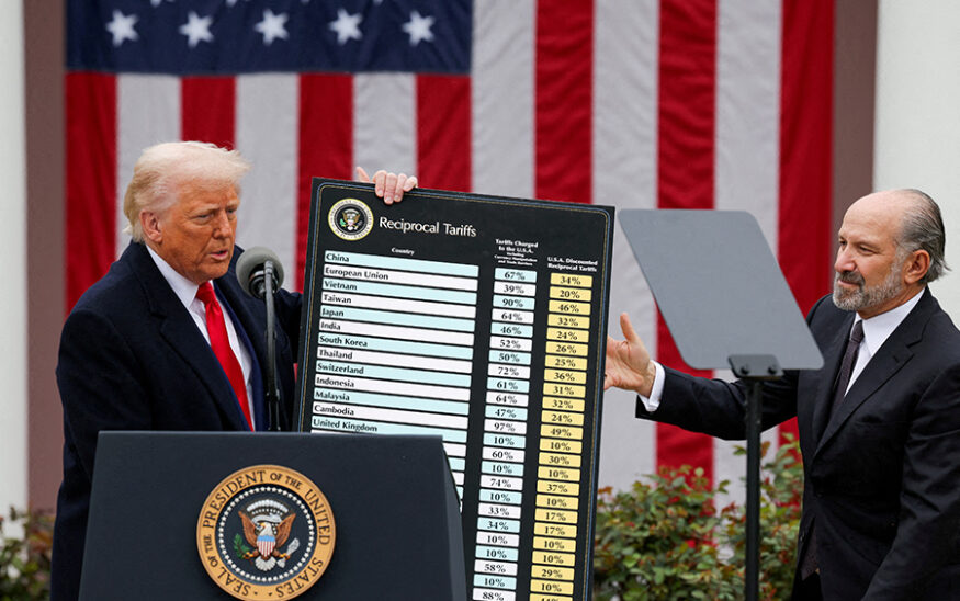 FILE PHOTO: U.S. President Donald Trump holds a chart next to U.S. Secretary of Commerce Howard Lutnick as Trump delivers remarks on tariffs in the Rose Garden at the White House in Washington, D.C., U.S., April 2, 2025. REUTERS/Carlos Barria//File Photo