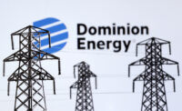 Electric power transmission pylon miniatures and Dominion Energy logo are seen in this illustration taken, December 9, 2022. REUTERS/Dado Ruvic/Illustration