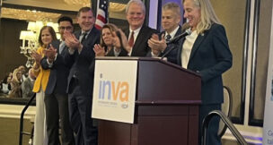 (From left) Lt. Gov. Ghazala Hashmi, Old Dominion University 2025 graduate Seth Smith, Virginia Economic Development Partnership President and CEO Jason El Koubi, Virginia Chamber Board Chair Jen Siciliano, Virginia Business Higher Education Council Board Chair Dennis Treacy and VBHEC President Kirk Cox applaud Gov. Abigail Spanberger as she takes stage Feb. 4, 2026 at the InternshipsVA announcement in Richmond. Photo by Kate Andrews/Virginia Business