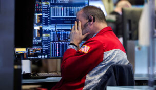 A trader works on the floor at the New York Stock Exchange (NYSE) in New York City, U.S., January 13, 2026. REUTERS/Brendan McDermid/File Photo