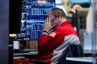 A trader works on the floor at the New York Stock Exchange (NYSE) in New York City, U.S., January 13, 2026. REUTERS/Brendan McDermid/File Photo