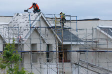 Workers place roofing material down on a Lennar housing development under construction in San Diego, California, U.S., March 11, 2025. REUTERS/Mike Blake