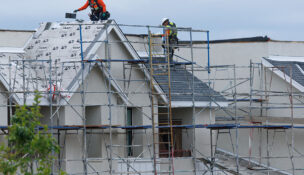 Workers place roofing material down on a Lennar housing development under construction in San Diego, California, U.S., March 11, 2025. REUTERS/Mike Blake