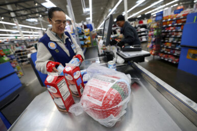 A cashier loads a turkey and other groceries for checkout at a Walmart Supercenter retail store in North Bergen, New Jersey, U.S., November 21, 2025. REUTERS/Mike Segar/File Photo