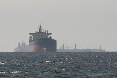 Cargo ships in the Gulf, near the Strait of Hormuz, as seen from northern Ras al-Khaimah, near the border with Oman’s Musandam governance, amid the U.S.-Israeli conflict with Iran, in United Arab Emirates, March 11, 2026. REUTERS/Stringer/File Photo REFILE - CORRECTING "TANKERS" TO "CARGO SHIPS" AND REMOVING ACTION "SAIL".