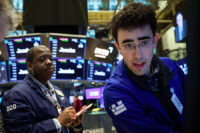Traders work on the floor at the New York Stock Exchange (NYSE) in New York City, U.S., March 23, 2026. REUTERS/Brendan McDermid