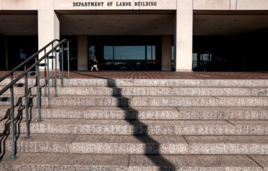 A woman walks into the U.S. Department of Labor, which published its weekly initial jobless claims report for the week ending January 3, in Washington, D.C., U.S., January 8, 2026. REUTERS/Evelyn Hockstein/File Photo