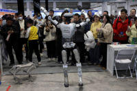 A humanoid robot dances in front of visitors at a job fair in Beijing, China, on March 14, 2026. Photo by Reuters/Florence Lo