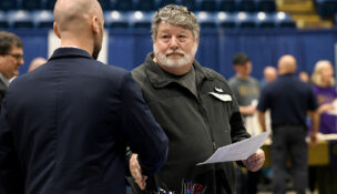Marty Lovelace stops by the Pyrotechnique by Grucci table during a job fair at the Salem Civic Center. Photo by Natalee Waters.