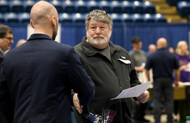 Marty Lovelace stops by the Pyrotechnique by Grucci table during a job fair at the Salem Civic Center. Photo by Natalee Waters.