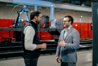 Huntington Ingalls Industries’ Eric Chewning (left) and Andy Lonsberry, Path Robotics’ CEO, announce their companies’ partnership.
