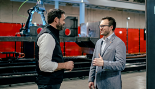 Huntington Ingalls Industries’ Eric Chewning (left) and Andy Lonsberry, Path Robotics’ CEO, announce their companies’ partnership.