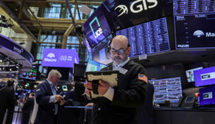 Traders work on the floor at the New York Stock Exchange (NYSE) in New York City, U.S., March 24, 2026. REUTERS/Jeenah Moon