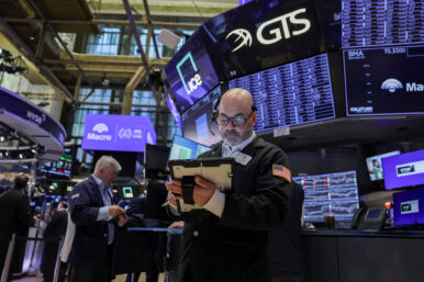 Traders work on the floor at the New York Stock Exchange (NYSE) in New York City, U.S., March 24, 2026. REUTERS/Jeenah Moon