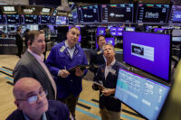 Traders work on the floor at the New York Stock Exchange (NYSE) in New York City, U.S., March 24, 2026. REUTERS/Jeenah Moon/File Photo