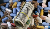 U.S. dollar banknotes and medicines are seen in this illustration taken, June 27, 2024. REUTERS/Dado Ruvic/Illustration