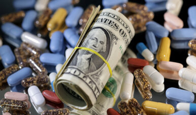 U.S. dollar banknotes and medicines are seen in this illustration taken, June 27, 2024. REUTERS/Dado Ruvic/Illustration
