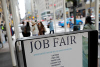Signage for a job fair is seen on 5th Avenue in Manhattan, New York City, U.S., September 3, 2021. REUTERS/Andrew Kelly/File Photo