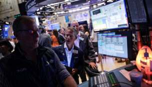 Traders work on the floor at the New York Stock Exchange in New York City, U.S., July 30, 2025. REUTERS/Jeenah Moon/File Photo