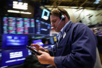 Traders work on the floor at the New York Stock Exchange (NYSE) in New York City, U.S., April 20, 2026. REUTERS/Brendan McDermid