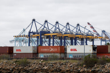Shipping containers wait to be transported along a railroad at the port of Los Angeles in Long Beach, California, U.S., March 10, 2026. REUTERS/Caroline Brehman/File Photo