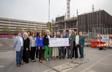 Officials with the Community Foundation Serving Western Virginia and Carilin Clinic stand in front of construction on the Carilion Taubman Cancer Center in Roanoke. Photo courtesy Carilion Clinic