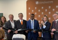 Secure Energy Future Center Managing Director Chelsea Olivieri, Hampton Roads Alliance President and CEO Doug Smith, Virginia Tech Board of Visitors Rector John Rocovich, Newport News Mayor Phillip Jones, Virginia Secretary of Commerce and Trade Carrie Chenery and Virginia Tech President Tim Sands hold a ribbon cutting to celebrate SEFC's opening. Photo by Josh Janney