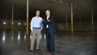 L to R: Mark Heath, president and CEO of Martinsville-Henry County Economic Development Corp., and Henry County Administrator Dale Wagoner show off the Patriot Centre Industrial Park’s new shell building. Photo by Natalee Waters