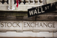 A street sign for Wall Street hangs in front of the New York Stock Exchange May 8, 2013. Stocks pushed further into record territory on Wednesday, driving the S&P 500 to an all-time high close for a fifth day, helped by strength in financials and technology. REUTERS/Lucas Jackson (UNITED STATES - Tags: BUSINESS)