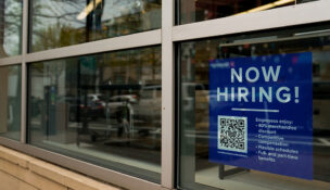 An employee hiring sign with a QR code is seen in a window of a business in Arlington, Virginia, U.S., April 7, 2023. REUTERS/Elizabeth Frantz/File Photo