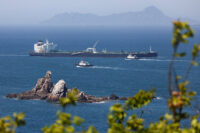Tugboats guide a crude oil tanker passing through the Strait of Hormuz with its Automatic Identification System transponder turned off, as it navigates the waters at Daesan port, in Seosan, South Korea, May 8, 2026. REUTERS/Kim Soo-hyeon/File Photo