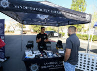 Job seeker Rueben Cota talks with recruiter San Diego sheriff's deputy Hubbard during a job fair for employees who are not vaccinated against the coronavirus disease (COVID-19), in Temecula, California, U.S., December 4, 2021. REUTERS/Denis Poroy