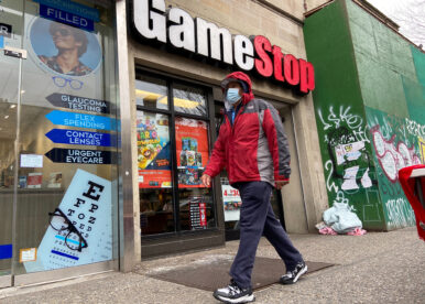 A man walks in front of a GameStop store in the Jackson Heights neighborhood of New York City, New York, U.S. January 27, 2021. Picture taken January 27, 2021. REUTERS/Nick Zieminski/ File Photo