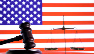 The U.S. flag, a judge gavel and a vintage scale are seen in this illustration taken August 6, 2024. REUTERS/Dado Ruvic/Illustration/File Photo