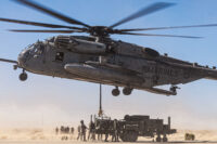 U.S. Marines with Combat Logistics Battalion 8, Combat Logistics Regiment 2, 2nd Marine Logistics Group and Marine Heavy Helicopter Squadron (HMH) 361, Marine Aircraft Group 16, 3rd Marine Air Wing, conduct a helicopter support team operation for the first evaluation of the air transportability of the Medium Range Air Defense Radar during Service Level Training Exercise 4-25 at the Marine Corps Air-Ground Combat Center, Twentynine Palms, California, on July 30, 2025. U.S. Marine Corps photo by Cpl. Judith Ann Lazaro
