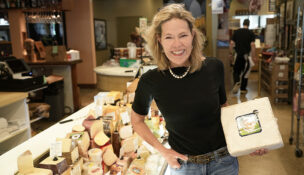 The Cheese Shop co-owner Mary Ellen Power looks forward to a wave of new customers celebrating the nation’s 250th birthday. Photo by Jay Paul