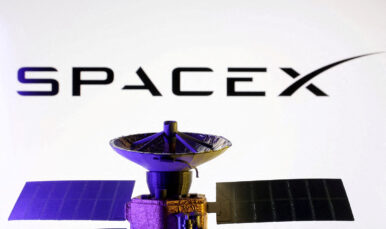 SpaceX logo and miniature satellite model are seen in this illustration created on March 10, 2025. REUTERS/Dado Ruvic/Illustration/File Photo