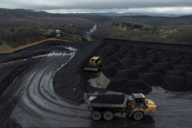 Workers transport and organise mounds of coal on a hilltop near an Arch Coal facility in Beckley, West Virginia, U.S., April 11, 2025. REUTERS/Adrees Latif/File Photo