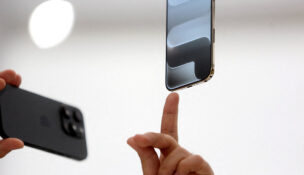 A person points to an iPhone during Apple's event at the Steve Jobs Theater on its campus in Cupertino, California, U.S. September 9, 2025. REUTERS/Manuel Orbegozo